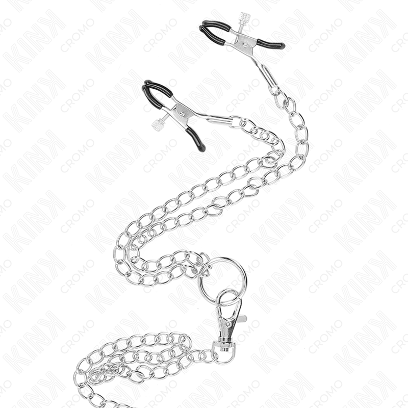Close-up of the KINK Anel de Pénis de Metal Triplo Cromado com Corrente e Clipes de Mamilo, showing its metallic finish and detailed design.