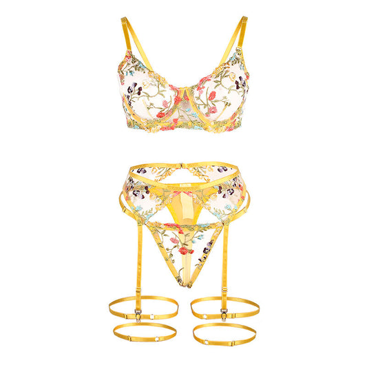 Close-up do Conjunto Lingerie SUBBLIME Floral Amarelo S/M, mostrando o sutiã, tanga e cinto-liga com detalhes florais.