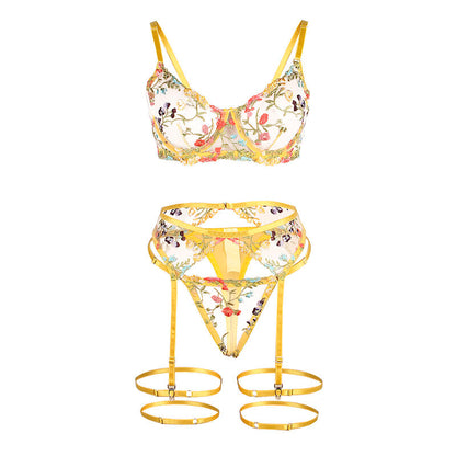 Conjunto de lingerie SUBBLIME floral amarelo, com sutiã, tanga e cinto-liga, exibindo detalhes e design.